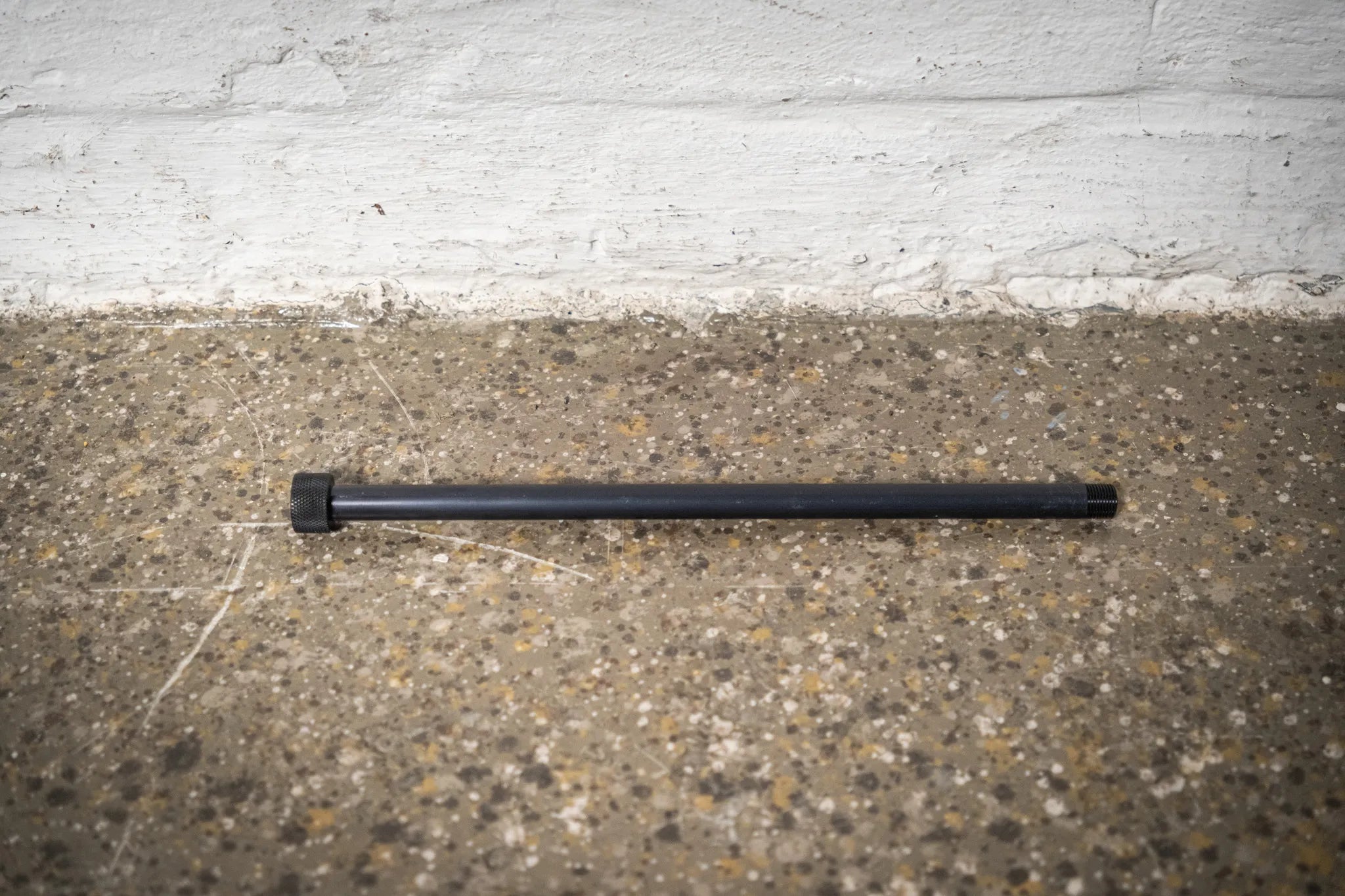 High-quality, black anodized XL thru-axle for the Hold My Bike (HMB) wheel mount, ensuring secure indoor bike wheel storage in apartments.