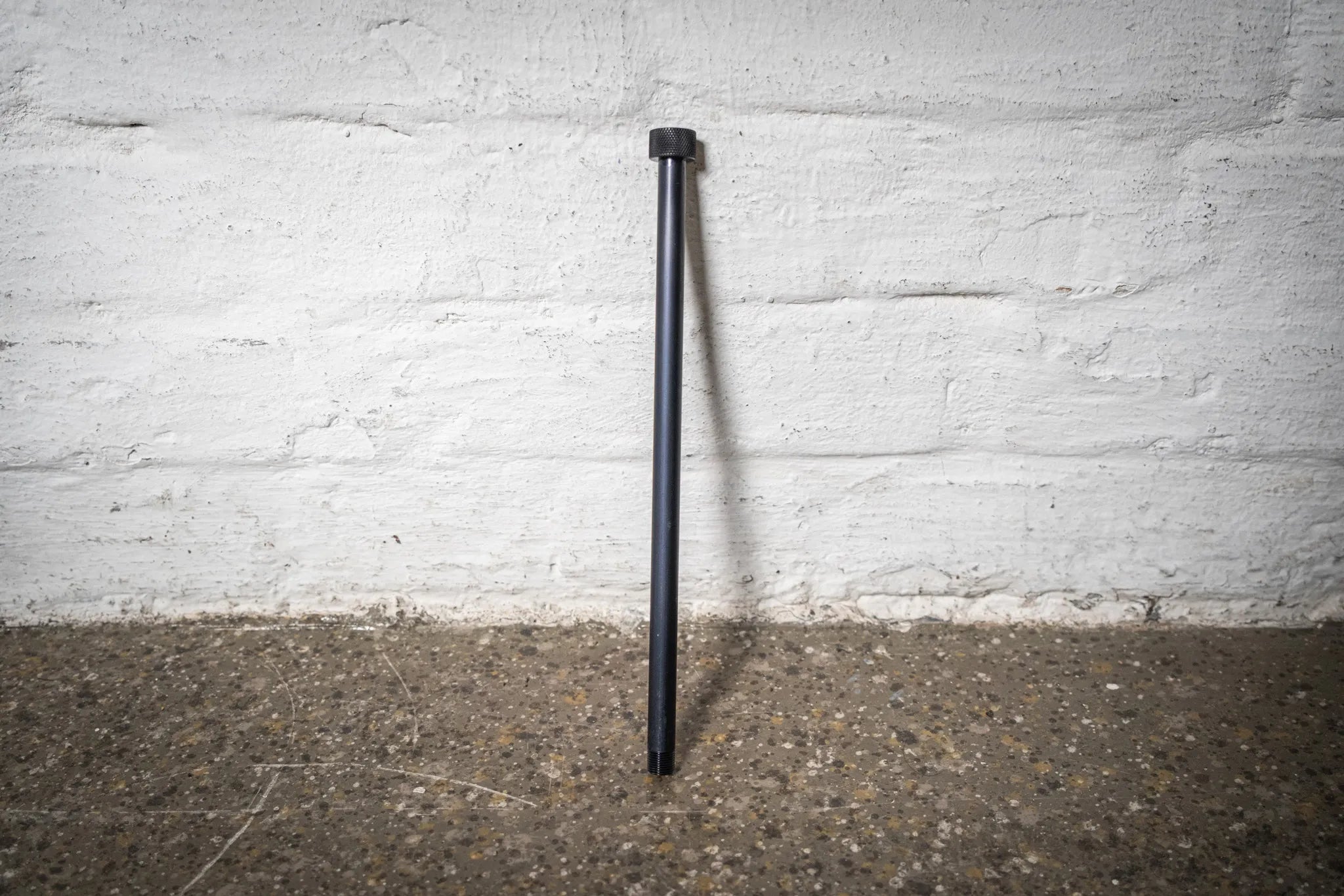 High-quality, black anodized thru-axle for the Hold My Bike (HMB) wheel mount, ensuring secure indoor bike wheel storage in apartments.